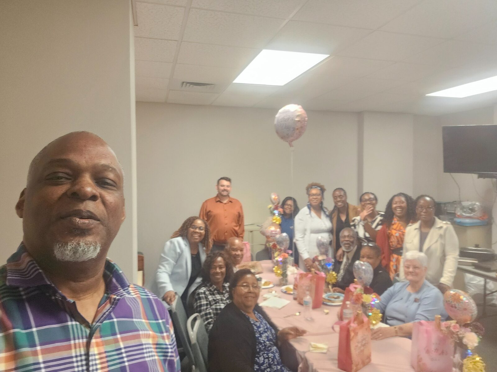 Hearts of Love Ministry members smiling together during a church celebration