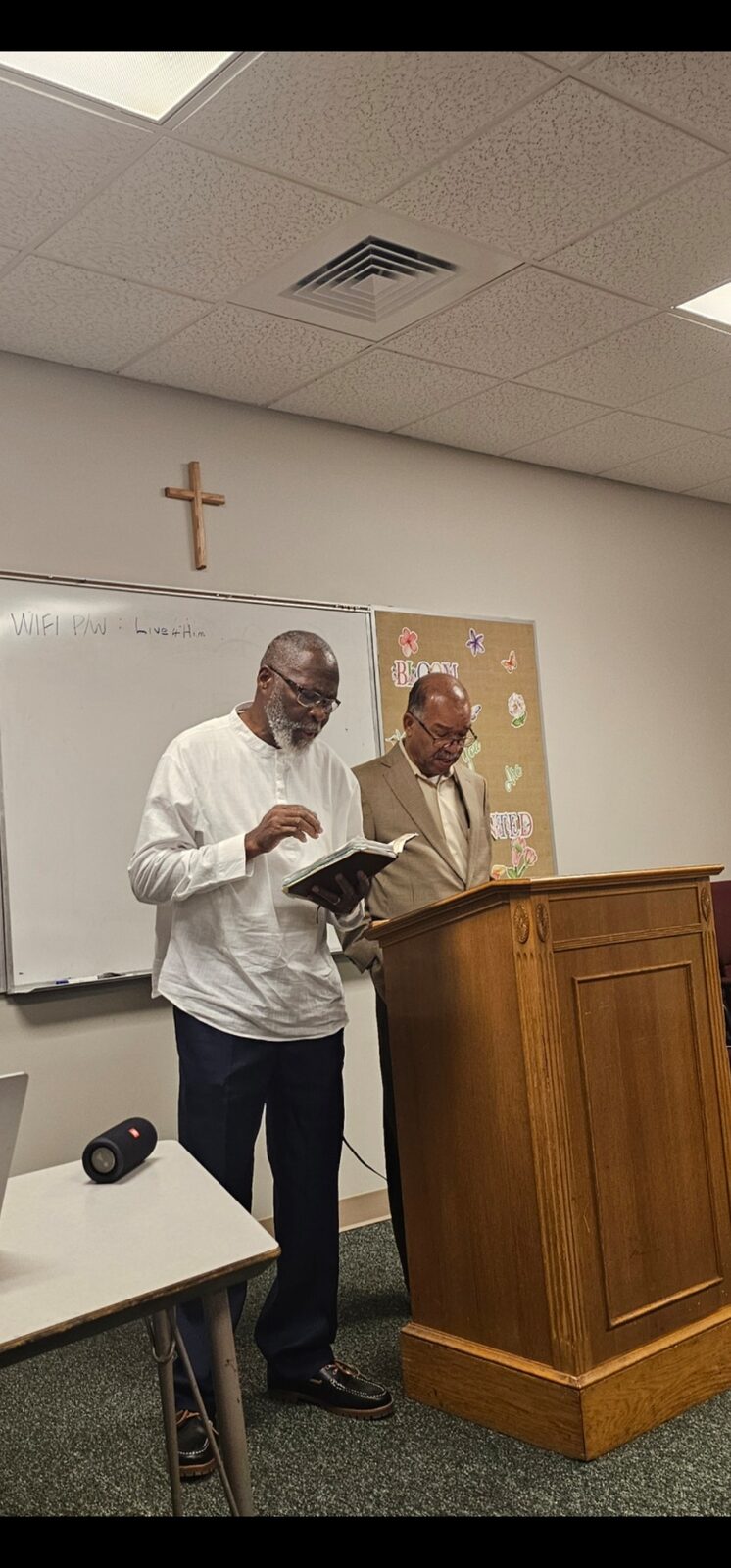 Two church leaders reading Scripture at the lectern