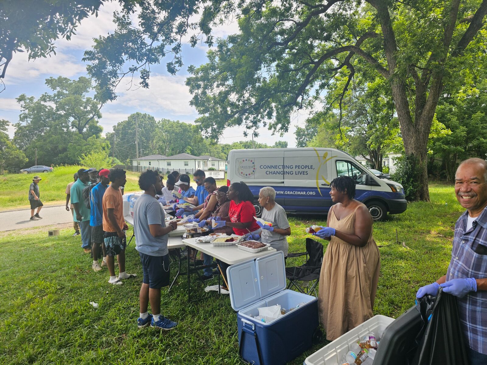 Community members receiving meals from volunteers