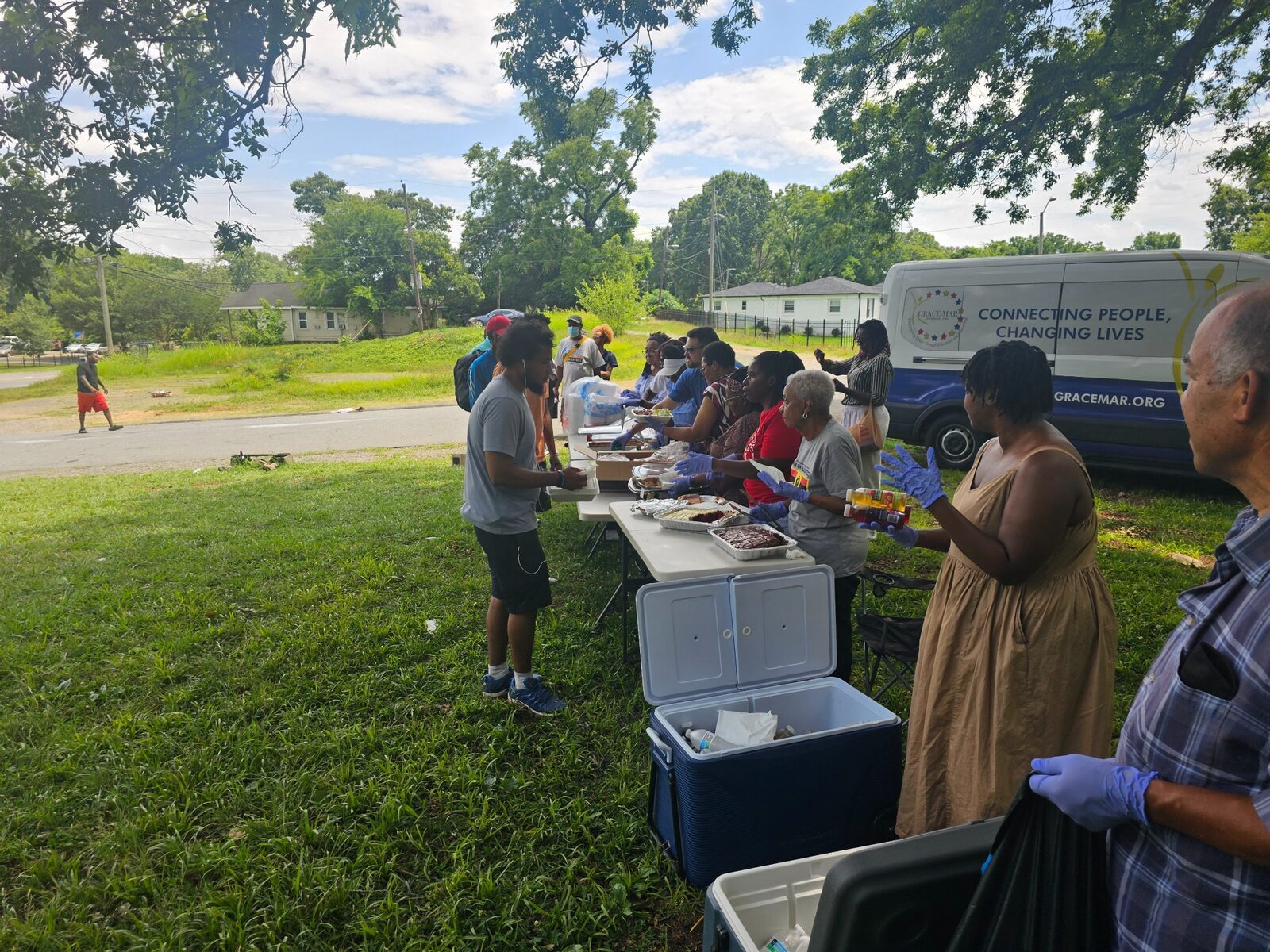 Volunteers sharing food with neighbors during a community outreach event